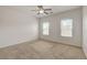 Neutral bedroom with two windows offering outside views and a ceiling fan at 1055 Fish Pond Ave, Henderson, NV 89014