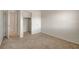 Bedroom with bright white walls, carpet flooring and a closet; doors open to another room at 1055 Fish Pond Ave, Henderson, NV 89014