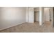 Neutral carpeted bedroom features a closet and access to an adjacent space at 1055 Fish Pond Ave, Henderson, NV 89014