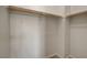 Walk-in closet featuring hanging rods and bright white walls, perfect for organizing clothes and accessories at 1055 Fish Pond Ave, Henderson, NV 89014