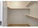 Spacious walk-in closet with wooden rods and white shelving at 1055 Fish Pond Ave, Henderson, NV 89014