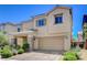 Charming two-story home featuring a stucco exterior, stone accents, and a well-manicured front yard at 1055 Fish Pond Ave, Henderson, NV 89014
