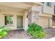 Inviting front porch with stone pillar accents and a brick-paved walkway leading to the front door at 1055 Fish Pond Ave, Henderson, NV 89014