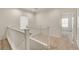 Bright hallway features a white banister staircase and neutral carpet at 1055 Fish Pond Ave, Henderson, NV 89014