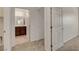 Hallway view of a bathroom with dark cabinets, double sinks and neutral tile at 1055 Fish Pond Ave, Henderson, NV 89014