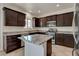 Updated kitchen featuring granite counters, stainless appliances and dark cabinets at 1055 Fish Pond Ave, Henderson, NV 89014