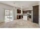 Open concept kitchen with stainless steel appliances, dark cabinetry and backyard access at 1055 Fish Pond Ave, Henderson, NV 89014