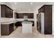 Kitchen features stainless steel appliances, dark cabinetry and a granite island at 1055 Fish Pond Ave, Henderson, NV 89014