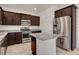 Bright kitchen featuring granite counters, stainless appliances and dark cabinets at 1055 Fish Pond Ave, Henderson, NV 89014