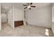 Open-concept living room with staircase and neutral tile flooring at 1055 Fish Pond Ave, Henderson, NV 89014