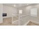 Upstairs loft area with two windows and carpet floors at 1055 Fish Pond Ave, Henderson, NV 89014