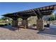 An outdoor ramada features stone pillars, dark wooden timbers, and picnic tables for enjoying community gathering at 1055 Fish Pond Ave, Henderson, NV 89014