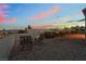 Cozy backyard patio with comfortable seating, desert landscaping, and city skyline views at 10901 Fort Valley Ave, Las Vegas, NV 89134