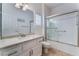 Bright bathroom featuring a single sink vanity with granite countertops and a shower-tub combo at 10901 Fort Valley Ave, Las Vegas, NV 89134