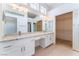 Bright bathroom with double vanity, neutral tile floor, and mirrored closet doors at 10901 Fort Valley Ave, Las Vegas, NV 89134