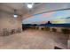 Spacious covered patio with tiled flooring, ceiling fans, and ample seating perfect for outdoor entertaining at 10901 Fort Valley Ave, Las Vegas, NV 89134