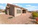 Exterior view of a home with a covered patio, mature landscaping, and a well-maintained yard at 10901 Fort Valley Ave, Las Vegas, NV 89134