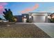 Charming single-story home with a three-car garage, desert landscaping, and sunset at 10901 Fort Valley Ave, Las Vegas, NV 89134