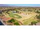 Scenic aerial view of a lush golf course within Sun City Summerlin, featuring manicured greens and water features at 10901 Fort Valley Ave, Las Vegas, NV 89134