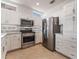 Kitchen features stainless steel appliances and white cabinets at 10901 Fort Valley Ave, Las Vegas, NV 89134
