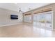 Modern living room featuring tile floors, shutters, ceiling fan, and television at 10901 Fort Valley Ave, Las Vegas, NV 89134