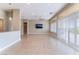 Spacious living room with tile flooring, ceiling fan, and large windows with shutters at 10901 Fort Valley Ave, Las Vegas, NV 89134
