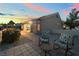 Inviting patio with tiled flooring, two chairs with flowered pattern cushions, and meticulously landscaped surroundings for outdoor enjoyment at 10901 Fort Valley Ave, Las Vegas, NV 89134