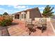 Charming outdoor seating area with comfortable chairs and a table on a brick-paved patio at 10901 Fort Valley Ave, Las Vegas, NV 89134