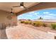 Charming covered patio with ceiling fans, brick pavers, and a view of the surrounding landscape at 10901 Fort Valley Ave, Las Vegas, NV 89134