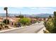 Scenic street view showcasing well-maintained homes, lush landscaping, and mountain views at 10901 Fort Valley Ave, Las Vegas, NV 89134