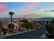 Picturesque street view with palm trees, desert landscaping, and a stunning skyline backdrop at 10901 Fort Valley Ave, Las Vegas, NV 89134