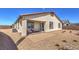 Backyard featuring a patio, desert landscaping, and a covered seating area at 1220 Eva Creek Dr # 35, North Las Vegas, NV 89084