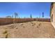 A spacious backyard featuring desert landscaping and a block wall at 1220 Eva Creek Dr # 35, North Las Vegas, NV 89084
