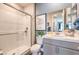Modern bathroom features a glass-enclosed shower and a vanity with a white countertop at 1220 Eva Creek Dr # 35, North Las Vegas, NV 89084