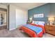 Comfortable bedroom featuring a blue accent wall and warm colored decor at 1220 Eva Creek Dr # 35, North Las Vegas, NV 89084