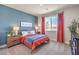 Inviting bedroom featuring a blue accent wall, warm colors, and a cozy atmosphere at 1220 Eva Creek Dr # 35, North Las Vegas, NV 89084