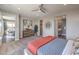 Spacious bedroom featuring neutral colors, a ceiling fan, and an ensuite bathroom at 1220 Eva Creek Dr # 35, North Las Vegas, NV 89084