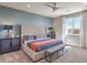 Comfortable bedroom featuring stylish wallpaper, a large window, and a ceiling fan at 1220 Eva Creek Dr # 35, North Las Vegas, NV 89084