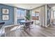 Dining area features a round wood table, modern chairs, and sliding glass doors to the patio at 1220 Eva Creek Dr # 35, North Las Vegas, NV 89084
