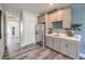Convenient kitchenette with gray cabinets, a stainless steel refrigerator, and a sink at 1220 Eva Creek Dr # 35, North Las Vegas, NV 89084