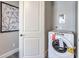 Laundry room with a modern washing machine, dryer, and white storage door at 1220 Eva Creek Dr # 35, North Las Vegas, NV 89084