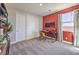Modern office space with a vibrant red accent wall and natural light at 1220 Eva Creek Dr # 35, North Las Vegas, NV 89084