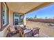 Covered patio features comfortable seating and a view of the landscaped backyard at 1220 Eva Creek Dr # 35, North Las Vegas, NV 89084