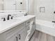 Stylish bathroom with double sinks, a bathtub, and modern finishes throughout the space at 1305 Pagentry Dr, North Las Vegas, NV 89031