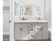 Bright bathroom showcasing a double vanity with marble countertop and stylish black hardware at 1305 Pagentry Dr, North Las Vegas, NV 89031