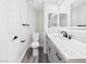 Bright bathroom featuring modern fixtures, vanity with beautiful counters, and sleek black hardware accents at 1305 Pagentry Dr, North Las Vegas, NV 89031