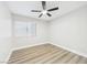 Bright bedroom featuring a ceiling fan, natural light from the window, and wood-style flooring at 1305 Pagentry Dr, North Las Vegas, NV 89031
