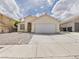 A charming single-story home with a two-car garage and desert landscaping at 1305 Pagentry Dr, North Las Vegas, NV 89031