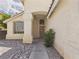 Front exterior view, shows landscaped yard, and door entry with beige stucco at 1305 Pagentry Dr, North Las Vegas, NV 89031
