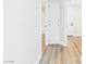 Bright hallway with wood-style floors and a white storage cabinet provides ample storage space at 1305 Pagentry Dr, North Las Vegas, NV 89031